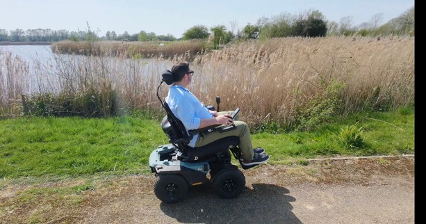Nick Wilson in the Quantum Outback all-terrain powerchair beside the reed beds at Stanwick Lakes